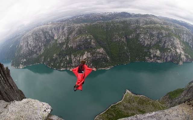 Watch This Daredevil Dive 1,300-Feet Off a Cliff Using...
